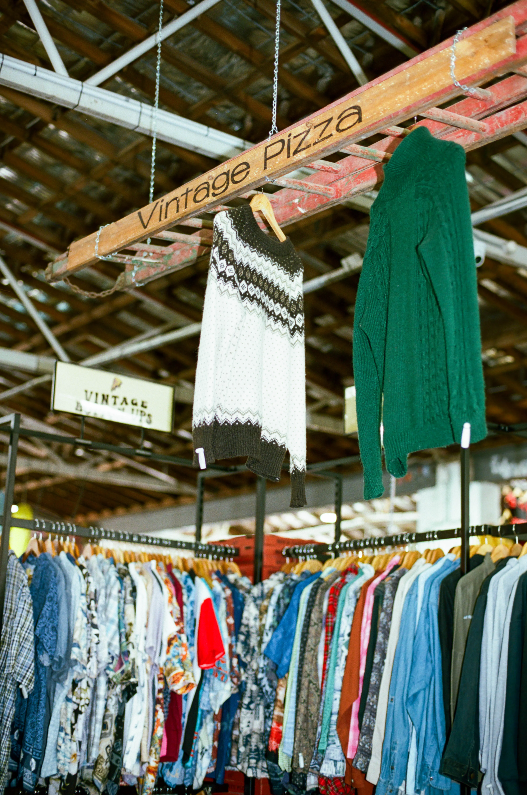Vintage Pizza clothing stall with knitwear and racks of vintage shirts in Adelaide