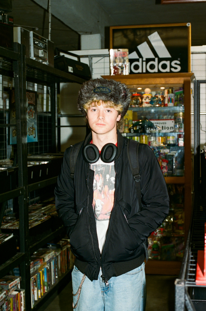 Shopper wearing vintage streetwear, headphones inside My Dead Grandpa Adelaide