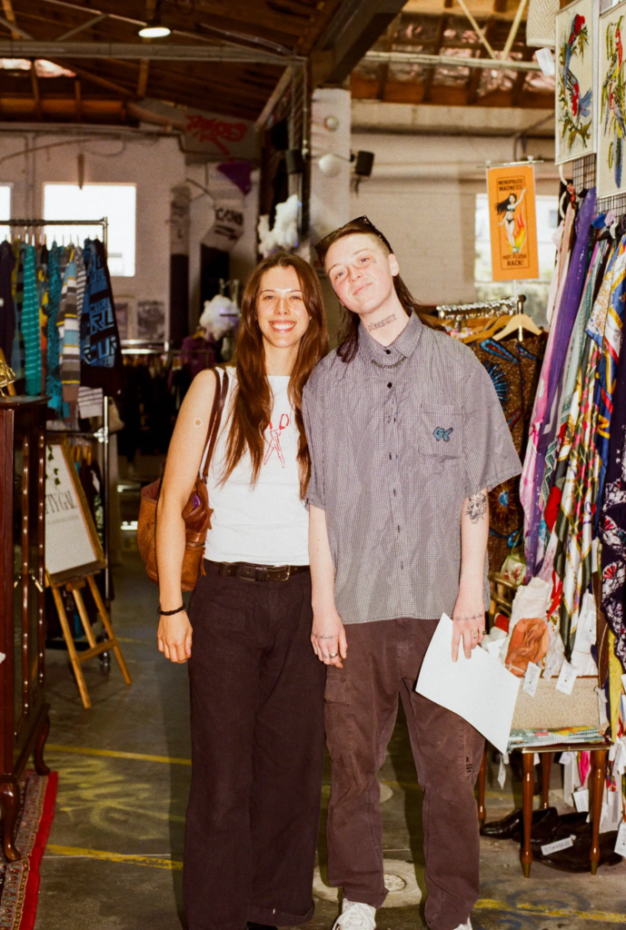 Shoppers standing beside colourful vintage clothing racks at From Here to Eternity in My Dead Grandpa Adelaide