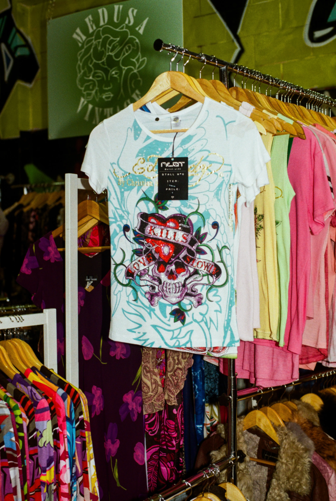 ALOT Y2K graphic tee on a clothing rack at My Dead Grandpa Adelaide vintage marketplace.