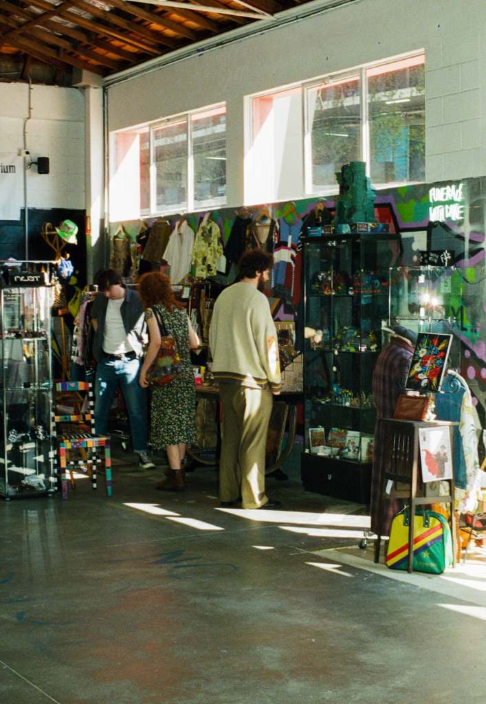 Shoppers browsing inside My Dead Grandpa, Adelaide’s vintage warehouse and marketplace with independent seller spaces.