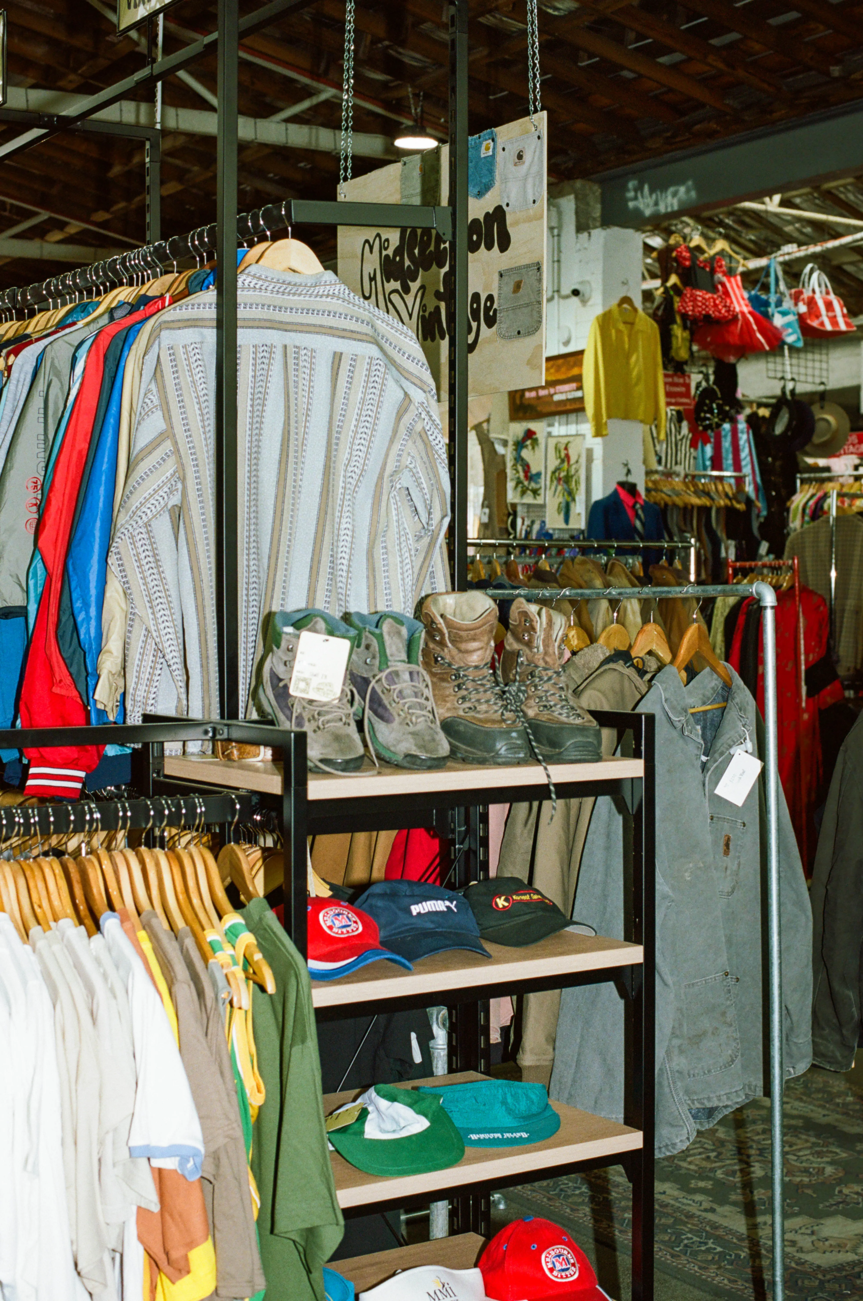 Vintage Pizza stall with second-hand shirts, jackets, boots and caps at My Dead Grandpa Adelaide
