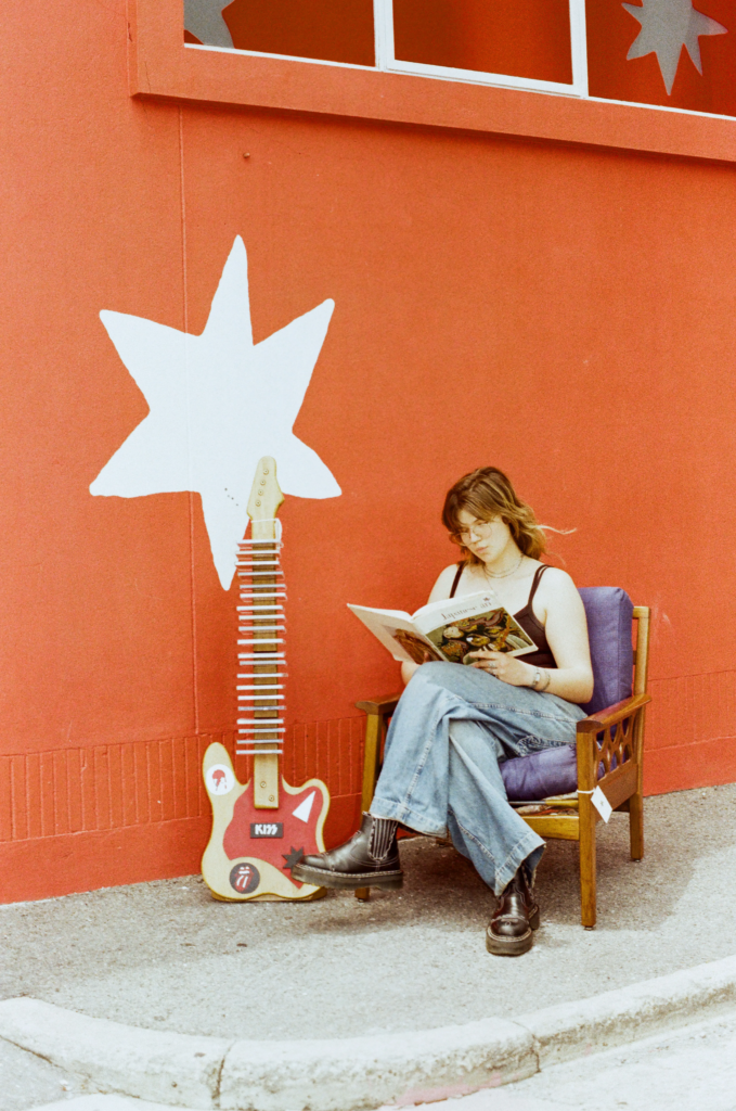 Deadbeat Sounds owner Esther reading outside My Dead Grandpa in Adelaide