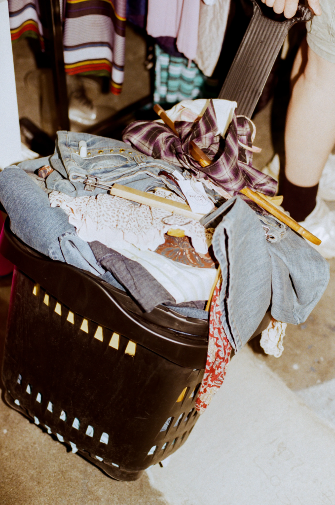 Basket of vintage clothing and accessories being restocked at From Here to Eternity Adelaide vintage stall