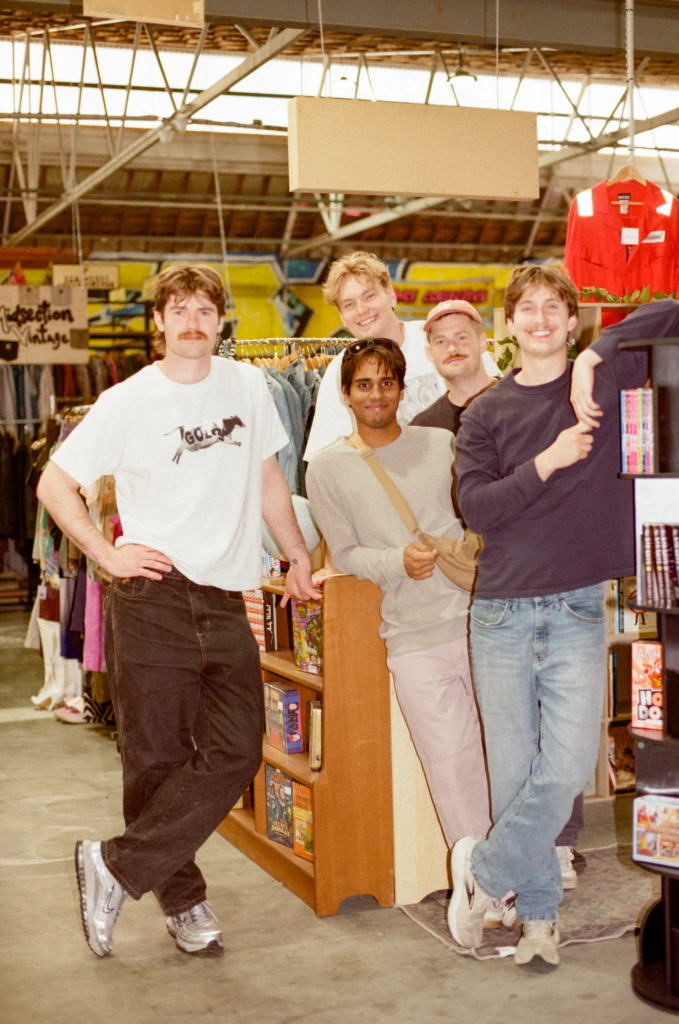 Group of customers posing beside vintage clothing racks at Juno inside My Dead Grandpa Adelaide