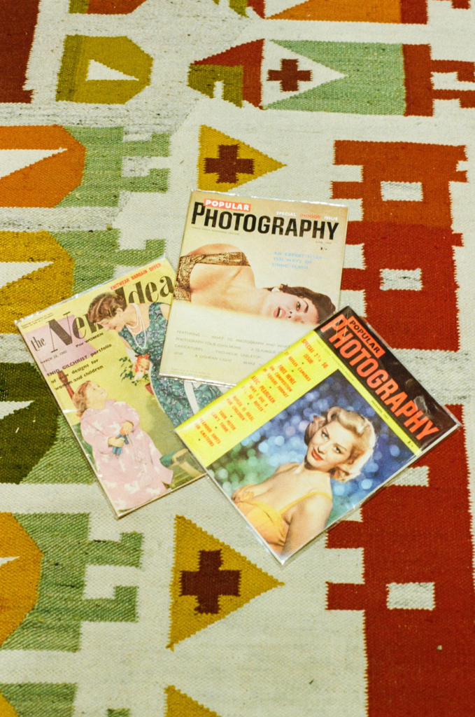 Vintage photography magazines displayed on patterned rug at Collectable Clutter Adelaide.