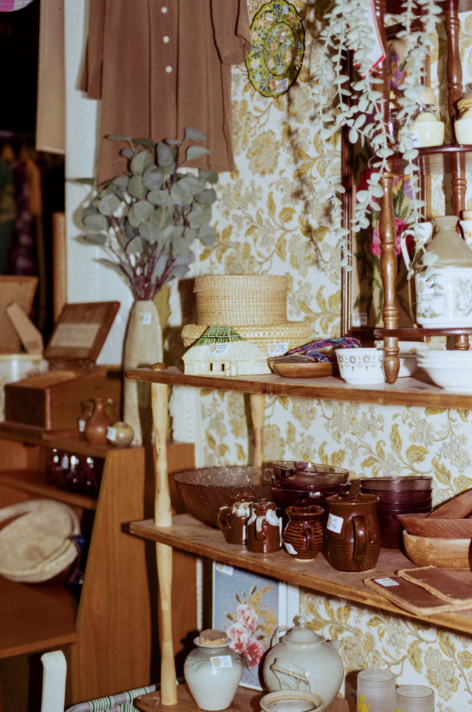 Vintage ceramics, teacups, baskets and retro homewares displayed on wooden shelves at Wattlebird Bazaar Adelaide.