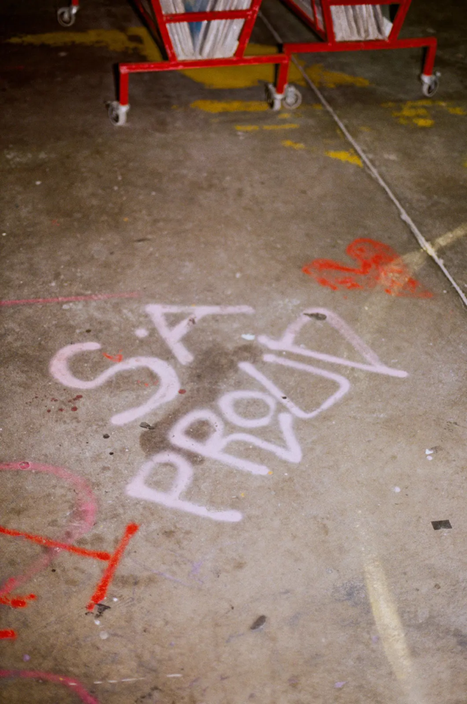 Graffiti-style spray paint on the concrete floor near Gamble Clothing Co at My Dead Grandpa Adelaide