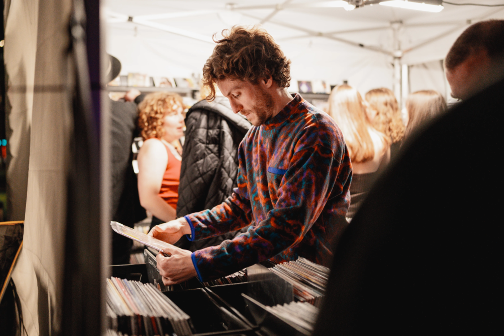 Customers browsing vinyl record crates at a Deadbeat Sounds event in Adelaide