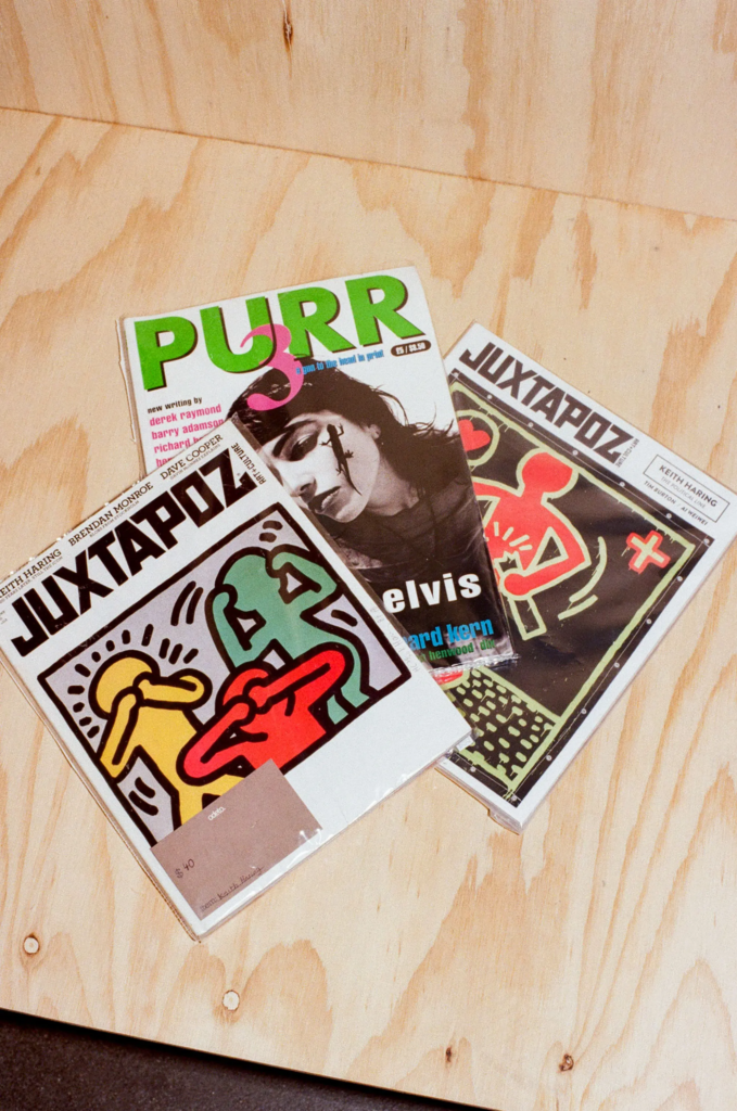 Vintage Juxtapoz and Purr magazines displayed on a timber counter at My Dead Grandpa Adelaide