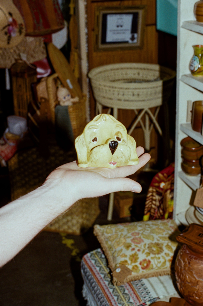 Hand holding yellow vintage dog ceramic decor inside Collectable Clutter at My Dead Grandpa Adelaide.