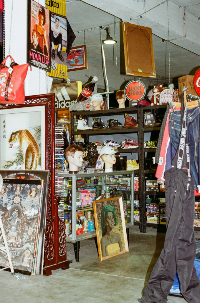 Scrapdogs homewares and clothing display with retro signs, framed art, shoes, CDs and vintage collectibles