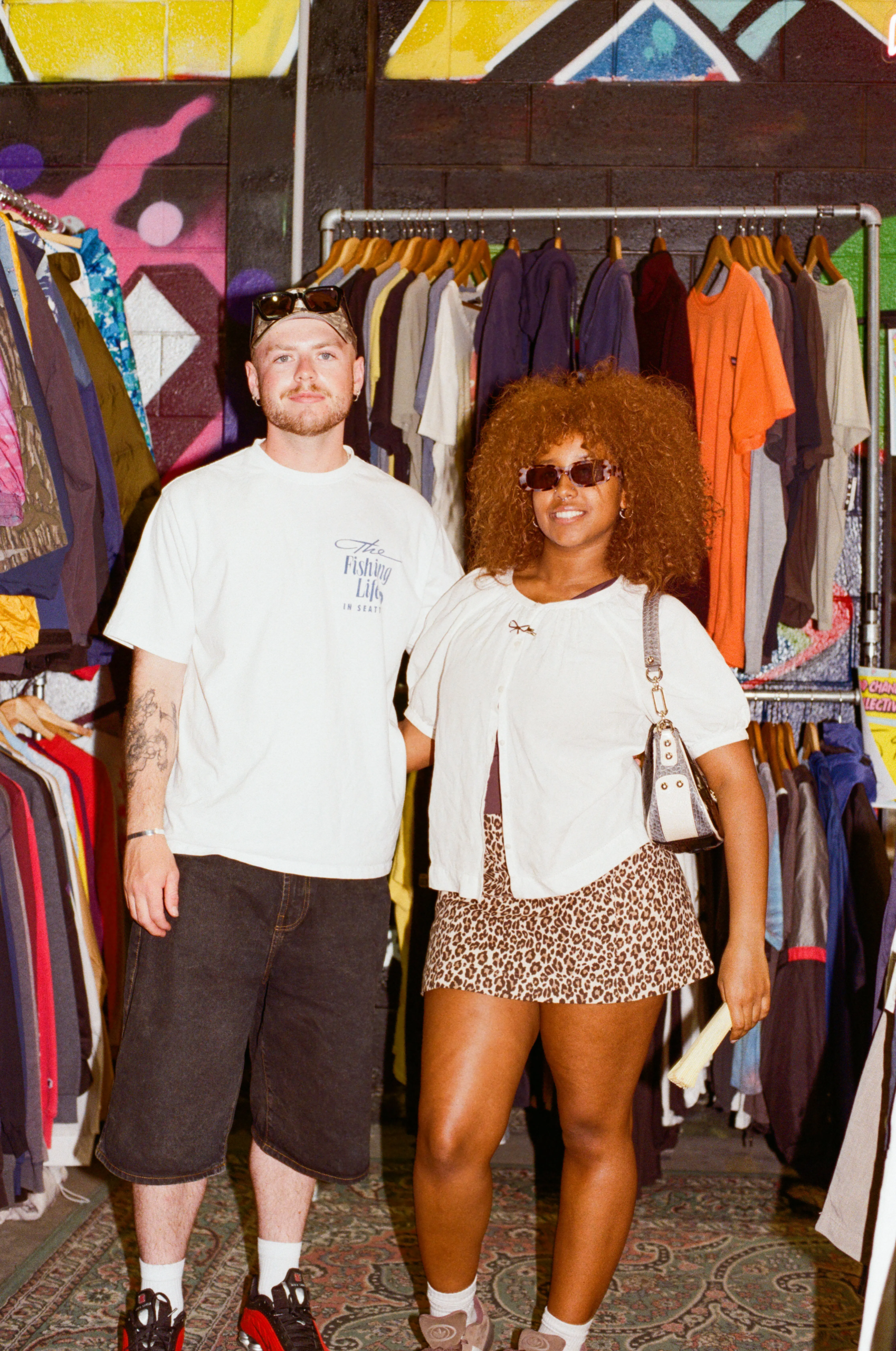 Two shoppers standing in front of racks of vintage clothing at My Dead Grandpa in Adelaide.
