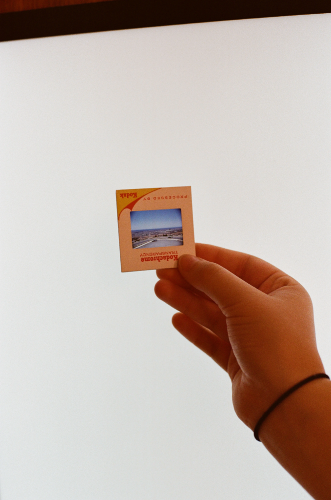 Hand holding a vintage Kodak photographic slide from Collectable Clutter at My Dead Grandpa Adelaide.