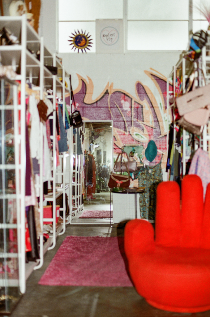 Rad.est Vintage stall with red hand chair, graffiti wall and Y2K fashion at My Dead Grandpa